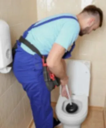 Professional plumber working on toilet repair in Southwark